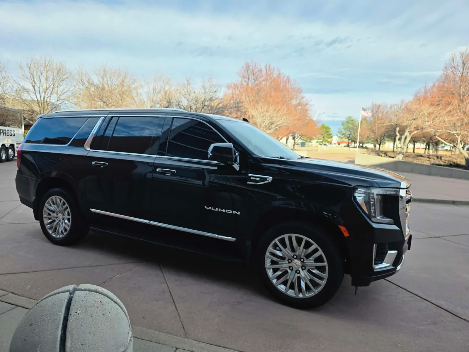 Black GMC Yukon XL parked at a Colorado terminal, ready for an airport transfer