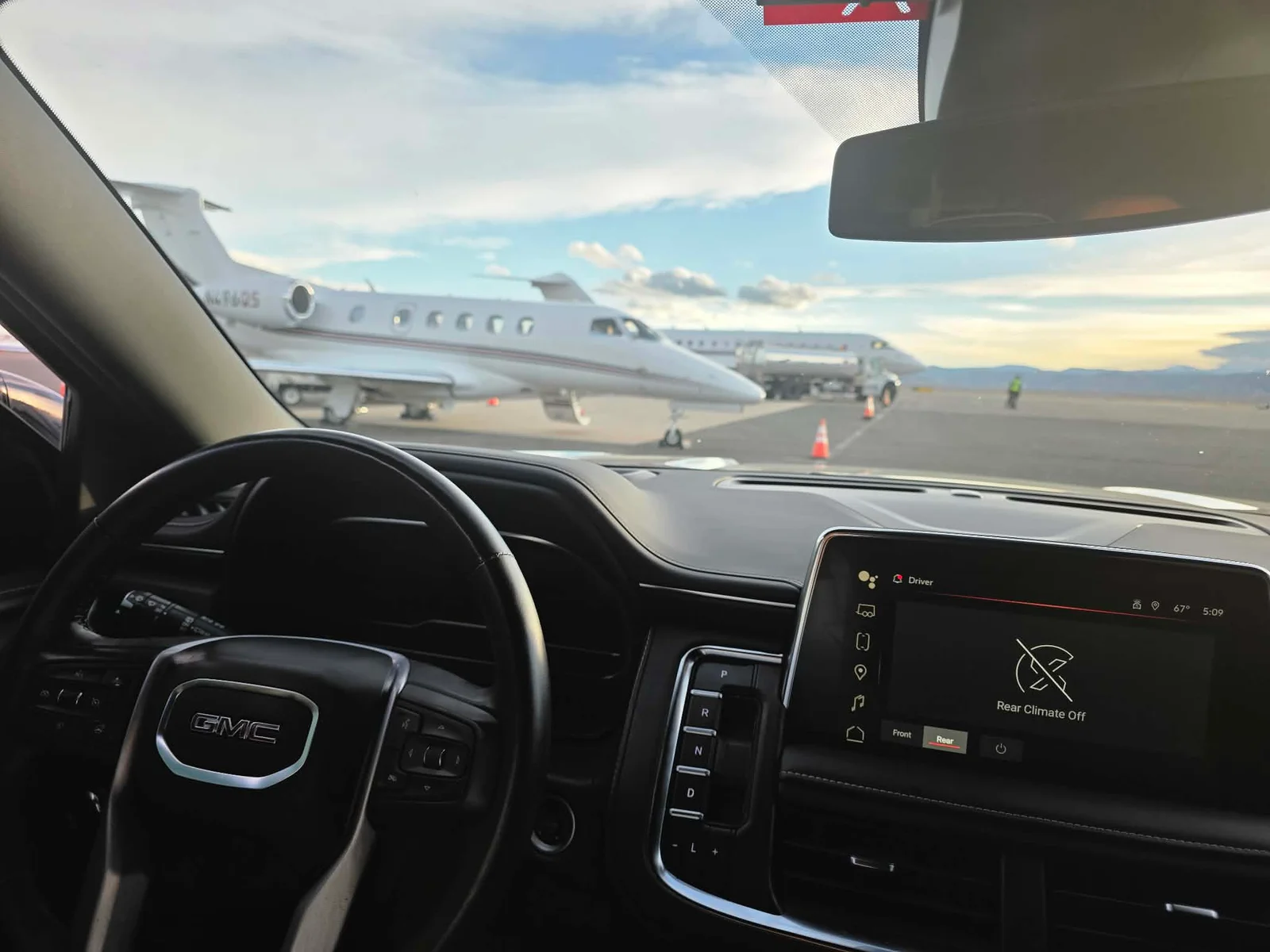 View from an Alpha SUV of private jets on the tarmac at a Colorado FBO